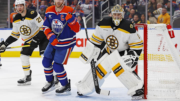 Dec 19, 2024; Edmonton, Alberta, CAN; Edmonton Oilers forward Connor McDavid (97) looks for a loose puck in front of Boston Bruins goaltender Jeremy Swayman (1)during the third period at Rogers Place. Mandatory Credit: Perry Nelson-Imagn Images