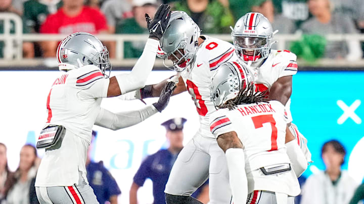 Sep 28, 2024; East Lansing, Michigan, USA; Ohio State Buckeyes linebacker Cody Simon (0) celebrates with teammates in the first half at Spartan Stadium on Saturday. Sep 28, 2024; East Lansing, Michigan, USA; Ohio State Buckeyes linebacker Cody Simon (0) celebrates with teammates in the first half at Spartan Stadium on Saturday.