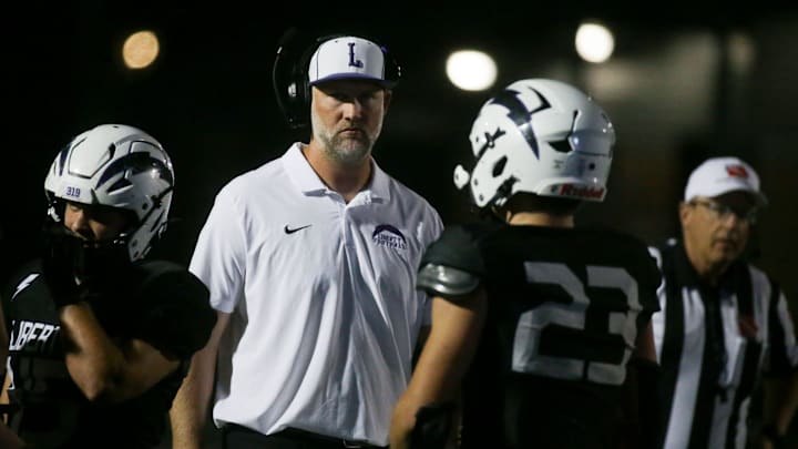 Iowa City Liberty head coach Scott Chandler talks with his team during a timeout Friday, Oct. 11, 2024 in North Liberty, Iowa.