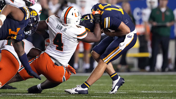 Oct 5, 2024; Berkeley, California, USA; Miami Hurricanes defensive lineman Rueben Bain Jr. (4) sacks California Golden Bears quarterback Fernando Mendoza (right) during the fourth quarter at California Memorial Stadium. Mandatory Credit: Darren Yamashita-Imagn Images