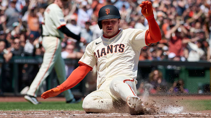 May 4, 2025; San Francisco, California, USA; San Francisco Giants catcher Patrick Bailey (14) slides into home plate to score a run against the Colorado Rockies during the fifth inning at Oracle Park. May 4, 2025; San Francisco, California, USA; San Francisco Giants catcher Patrick Bailey (14) slides into home plate to score a run against the Colorado Rockies during the fifth inning at Oracle Park.