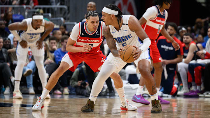 Orlando Magic forward Paolo Banchero (5) handles the ball against Washington Wizards forward Kyshawn George (18) during the second quarter at Capital One Arena.
