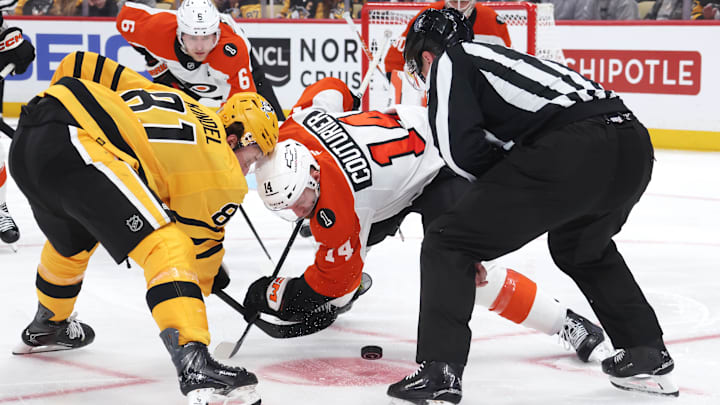 Apr 18, 2026; Pittsburgh, Pennsylvania, USA; Pittsburgh Penguins center Ben Kindel (81) and Philadelphia Flyers center Sean Couturier (14) take a third period face-off during the third period in game one of the first round of the 2026 Stanley Cup Playoffs at PPG Paints Arena.