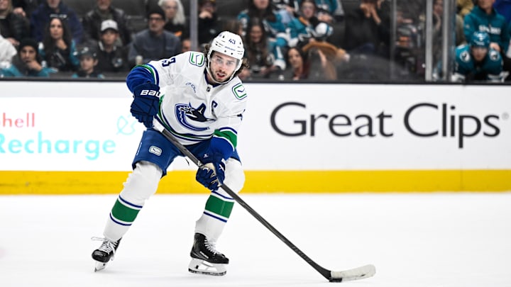 Nov 28, 2025; San Jose, California, USA; Vancouver Canucks defenseman Quinn Hughes (43) controls the puck against the San Jose Sharks in the third period at SAP Center at San Jose. Mandatory Credit: Eakin Howard-Imagn Images