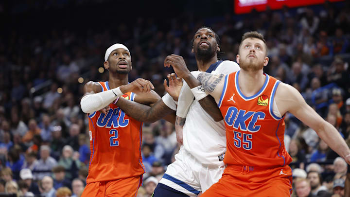 Nov 26, 2025; Oklahoma City, Oklahoma, USA; Oklahoma City Thunder guard Shai Gilgeous-Alexander (2), center Isaiah Hartenstein (55) and Minnesota Timberwolves center Naz Reid (11) react as a rebound comes down during the second half at Paycom Center. Mandatory Credit: Alonzo Adams-Imagn Images