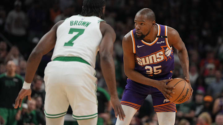 Mar 26, 2025; Phoenix, Arizona, USA; Phoenix Suns forward Kevin Durant (35) shields the ball from Boston Celtics guard Jaylen Brown (7) during the first half at Footprint Center. Mandatory Credit: Rick Scuteri-Imagn Images