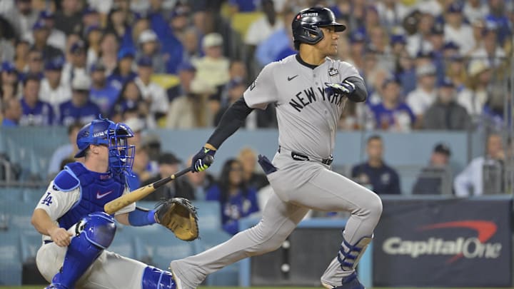 Oct 25, 2024; Los Angeles, California, USA; New York Yankees outfielder Juan Soto (22) hits a single in the sixth inning against the Los Angeles Dodgers during game one of the 2024 MLB World Series at Dodger Stadium. Mandatory Credit:  Jayne Kamin-Oncea-Imagn Images