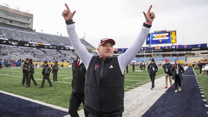 Nov 29, 2025; Morgantown, West Virginia, USA; Texas Tech Red Raiders head coach Joey McGuire celebrates with fans after defeating the West Virginia Mountaineers at Milan Puskar Stadium. Mandatory Credit: Ben Queen-Imagn Images Nov 29, 2025; Morgantown, West Virginia, USA; Texas Tech Red Raiders head coach Joey McGuire celebrates with fans after defeating the West Virginia Mountaineers at Milan Puskar Stadium. Mandatory Credit: Ben Queen-Imagn Images