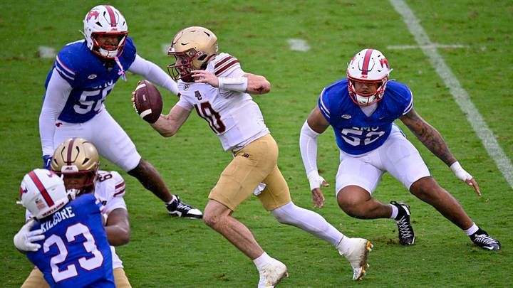 Oct 3, 2026; Dallas, Texas, USA; Boston College Eagles quarterback Mason McKenzie (10) runs with the ball past SMU Mustangs defensive end Aakil Washington (58) and defensive end Jahkai Lang (52) during the first half at Gerald J. Ford Stadium. Mandatory Credit: Jerome Miron-Imagn Images Oct 3, 2026; Dallas, Texas, USA; Boston College Eagles quarterback Mason McKenzie (10) runs with the ball past SMU Mustangs defensive end Aakil Washington (58) and defensive end Jahkai Lang (52) during the first half at Gerald J. Ford Stadium. Mandatory Credit: Jerome Miron-Imagn Images