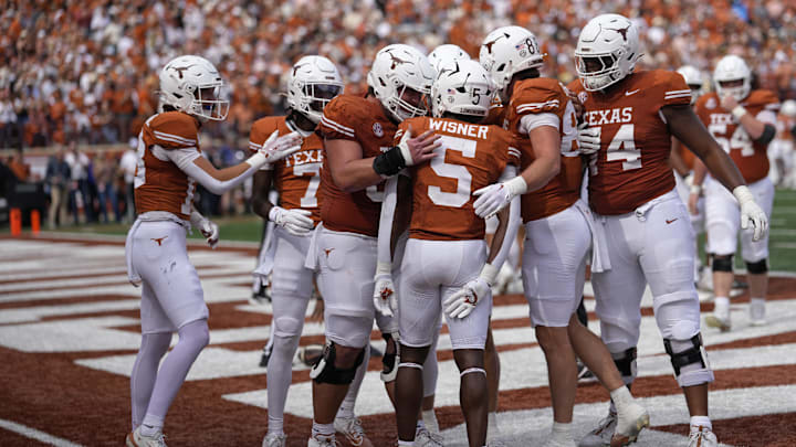 Texas Longhorns celebrate after running back Quintrevion Wisner (5) runs for a touchdown in the first half against the Vanderbilt Commodores at Darrell K Royal-Texas Memorial Stadium. Texas Longhorns celebrate after running back Quintrevion Wisner (5) runs for a touchdown in the first half against the Vanderbilt Commodores at Darrell K Royal-Texas Memorial Stadium.