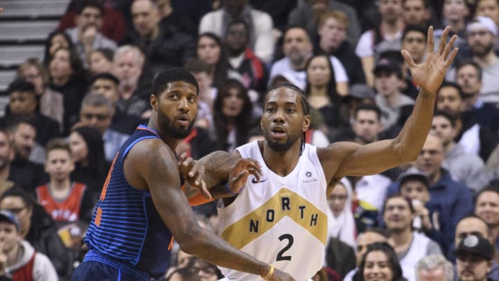 Mar 22, 2019; Toronto, Ontario, CAN; Toronto Raptors forward Kawhi Leonard (2) battles with Oklahoma City Thunder forward Paul George (13) during the first quarter at Scotiabank Arena. Mandatory Credit: Nick Turchiaro-USA TODAY Sports