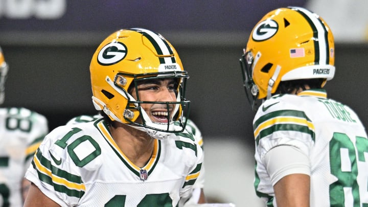 Green Bay Packers quarterback Jordan Love (10) reacts with wide receiver Samori Toure (83) against the Minnesota Vikings.