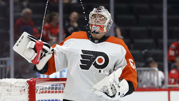 Sep 22, 2024; Washington, District of Columbia, USA; Philadelphia Flyers goaltender Carson Bjarnason (64) watches water squirted from his bottle during a timeout against the Washington Capitals in the third period at Capital One Arena.