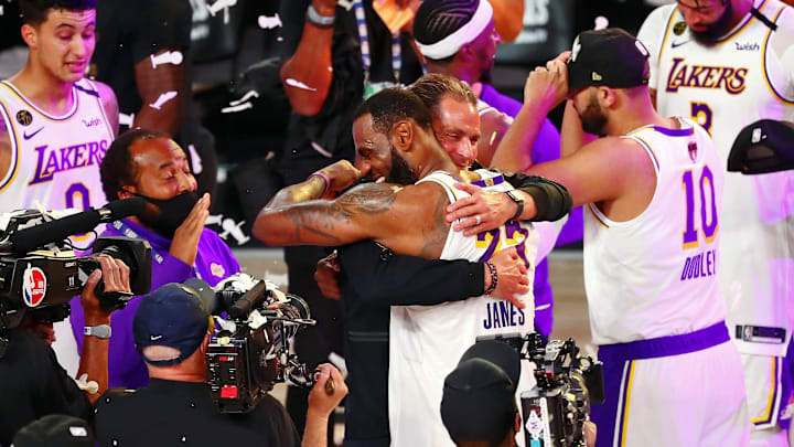 Oct 11, 2020; Lake Buena Vista, Florida, USA; Los Angeles Lakers forward LeBron James (23) hugs general manager Rob Pelinka after game six of the 2020 NBA Finals at AdventHealth Arena. The Los Angeles Lakers won 106-93 to win the series. Mandatory Credit: Kim Klement-USA TODAY Sports