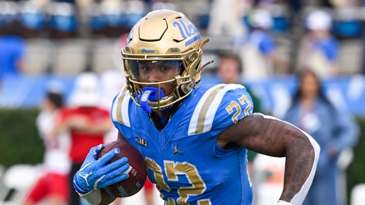Nov 30, 2024; Pasadena, California, USA; UCLA Bruins running back Keegan Jones (22) carries the ball during the second quarter against the Fresno State Bulldogs at Rose Bowl. Mandatory Credit: Robert Hanashiro-Imagn Images