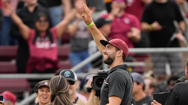 Retired Indianapolis Colts quarterback Luck waves at fans during a game at Stanford Stadium. Retired Indianapolis Colts quarterback Luck waves at fans during a game at Stanford Stadium.