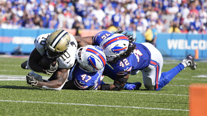 Sep 28, 2025; Orchard Park, New York, USA;  New Orleans Saints wide receiver Brandin Cooks (10) is tackled by Buffalo Bills cornerback Christian Benford (47) and linebacker Dorian Williams (42)