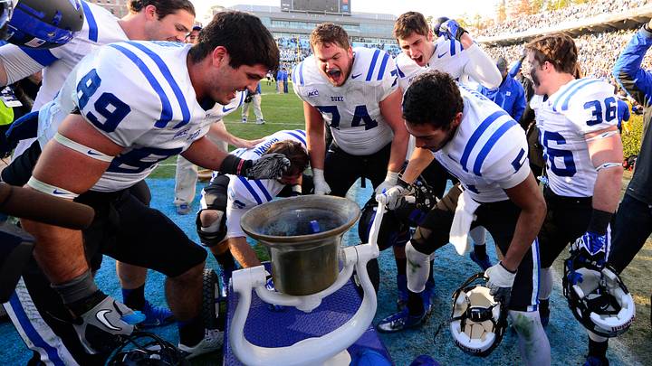 Nov 30, 2013; Chapel Hill, NC, USA; Duke Blue Devils tight end Braxton Deaver (89) and linebacker Kyler Brown (56) and guard Dave Harding (74) and wide receiver Max McCaffrey (87) and wide receiver Brandon Braxton (5) and safety Christian Conway (36) ring the victory bell after the game. The Blue Devils defeated the North Carolina Tar Heels 27-25 at Kenan Memorial Stadium. Mandatory Credit: Bob Donnan-USA TODAY Sports Nov 30, 2013; Chapel Hill, NC, USA; Duke Blue Devils tight end Braxton Deaver (89) and linebacker Kyler Brown (56) and guard Dave Harding (74) and wide receiver Max McCaffrey (87) and wide receiver Brandon Braxton (5) and safety Christian Conway (36) ring the victory bell after the game. The Blue Devils defeated the North Carolina Tar Heels 27-25 at Kenan Memorial Stadium. Mandatory Credit: Bob Donnan-USA TODAY Sports
