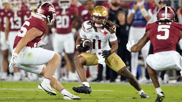 Sep 13, 2025; Stanford, California, USA; Boston College Eagles wide receiver Lewis Bond (11) runs after a catch against Stanford Cardinal linebacker Matt Rose (left) and safety Jay Green (5) during the second quarter at Stanford Stadium. Mandatory Credit: Darren Yamashita-Imagn Images Sep 13, 2025; Stanford, California, USA; Boston College Eagles wide receiver Lewis Bond (11) runs after a catch against Stanford Cardinal linebacker Matt Rose (left) and safety Jay Green (5) during the second quarter at Stanford Stadium. Mandatory Credit: Darren Yamashita-Imagn Images