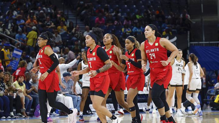 Atlanta Dream players walk back to the bench during the second half of a WNBA game against the Chicago Sky at Wintrust Arena. 