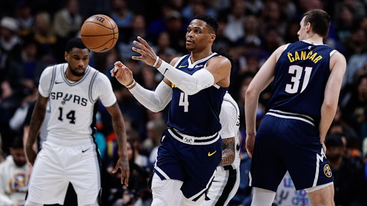 Apr 2, 2025; Denver, Colorado, USA; Denver Nuggets guard Russell Westbrook (4) grabs a pass as forward Vlatko Cancar (31) and San Antonio Spurs guard Blake Wesley (14) defend in the first quarter at Ball Arena. Mandatory Credit: Isaiah J. Downing-Imagn Images