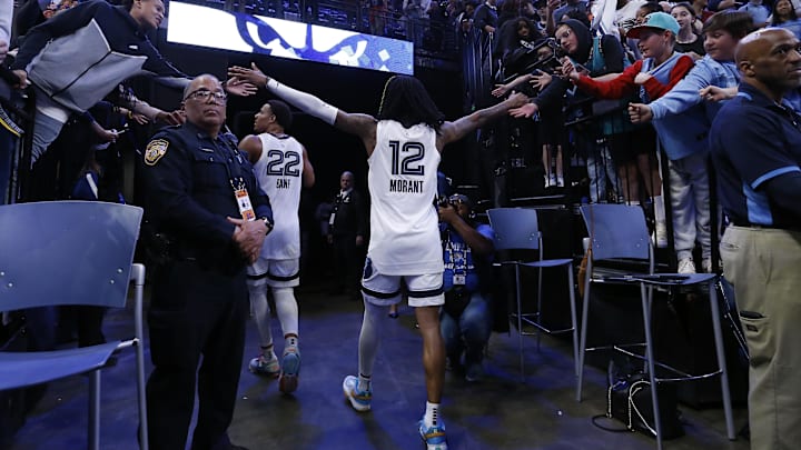 Apr 4, 2023; Memphis, Tennessee, USA; Memphis Grizzlies guard Ja Morant (12) interacts with fans as he walks off the court after the game against the Portland Trail Blazers at FedExForum. Mandatory Credit: Petre Thomas-USA TODAY Sports