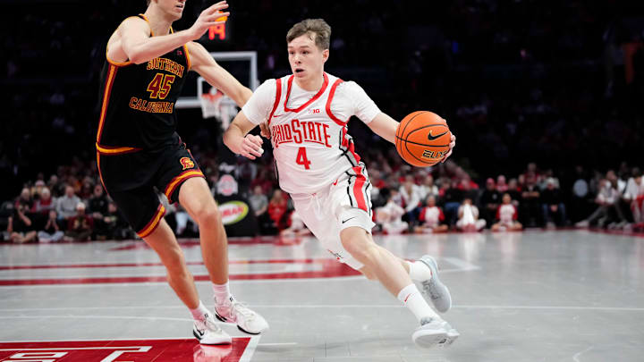 Ohio State Buckeyes guard Gabe Cupps (4) dribbles past USC Trojans center Gabe Dynes (45) during the first half of the NCAA men's basketball game at the Schottenstein Center on Feb. 11, 2026. Ohio State Buckeyes guard Gabe Cupps (4) dribbles past USC Trojans center Gabe Dynes (45) during the first half of the NCAA men's basketball game at the Schottenstein Center on Feb. 11, 2026.