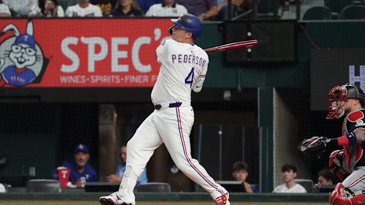 Sep 23, 2025; Arlington, Texas, USA; Texas Rangers first baseman Joc Pederson (4) follows through on a solo home run during the first inning against the Minnesota Twins at Globe Life Field. Mandatory Credit: Raymond Carlin III-Imagn Images