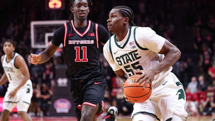 Jan 27, 2026; Piscataway, New Jersey, USA; Michigan State Spartans forward Coen Carr (55) goes to the basket against Rutgers Scarlet Knights forward Christopher Nwuli (11) during the first half at Jersey Mike's Arena. Mandatory Credit: Vincent Carchietta-Imagn Images
