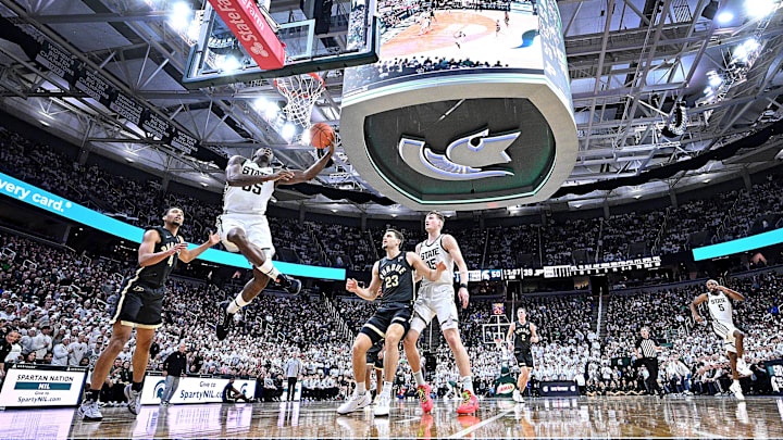 Feb 18, 2025; East Lansing, Michigan, USA; Michigan State Spartans forward Coen Carr (55) drives to the basket against Purdue Boilermakers forward Trey Kaufman-Renn (4) during the second half at Jack Breslin Student Events Center. Mandatory Credit: Dale Young-Imagn Images Feb 18, 2025; East Lansing, Michigan, USA; Michigan State Spartans forward Coen Carr (55) drives to the basket against Purdue Boilermakers forward Trey Kaufman-Renn (4) during the second half at Jack Breslin Student Events Center. Mandatory Credit: Dale Young-Imagn Images