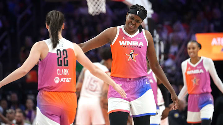 Team WNBA center Jonquel Jones (35) high-fives teammate Caitline Clark (22) after her assist against Team USA during the WNBA All-Star Game at Footprint Center in Phoenix on July 20, 2024.