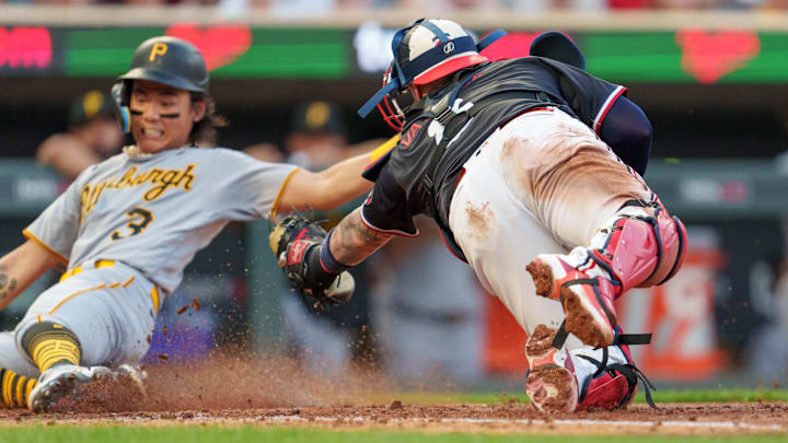 Aug 19, 2023; Minneapolis, Minnesota, USA; Pittsburgh Pirates second baseman Ji Hwan Bae (3) scores as Minnesota Twins catcher Christian Vazquez (8) dives for the tag in the sixth inning at Target Field. Mandatory Credit: Matt Blewett-USA TODAY Sports