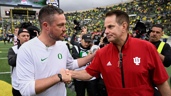 Oct 11, 2025; Eugene, Oregon, USA; Oregon Ducks head coach Dan Lanning shakes hands with Indiana Hoosiers head coach Curt Cignetti after Indiana defeated Oregon by the score of 30-20 at Autzen Stadium. Mandatory Credit: Troy Wayrynen-Imagn Images