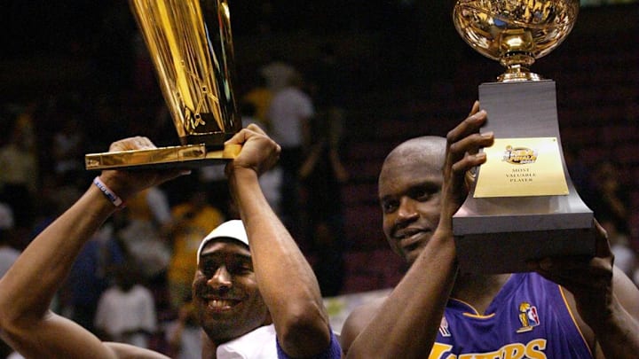 June 12, 2002; East Rutherford, NJ; The Lakers Kobe Bryant holds up the Championship trophy along with teammate Shaquille O'Neal who holds up his third MVP trophy. Mandatory Credit:  Michael J. Terola/Abury Park Press-USA TODAY NETWORK 