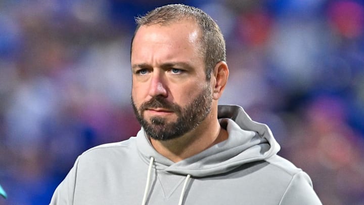 Miami Dolphins offensive coordinator Frank Smith on the field before a game against the Buffalo Bills at Highmark Stadium in 2025.