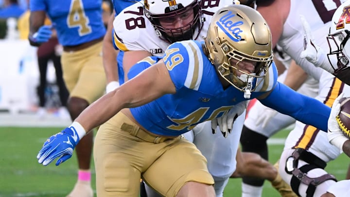 Oct 12, 2024; Pasadena, California, USA; UCLA Bruins linebacker Carson Schwesinger (49) moves to tackle Minnesota Golden Gophers running back Darius Taylor (1) during the first half at Rose Bowl. Mandatory Credit: Robert Hanashiro-Imagn Images Oct 12, 2024; Pasadena, California, USA; UCLA Bruins linebacker Carson Schwesinger (49) moves to tackle Minnesota Golden Gophers running back Darius Taylor (1) during the first half at Rose Bowl. Mandatory Credit: Robert Hanashiro-Imagn Images