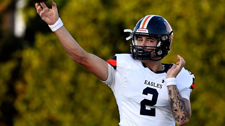 Nashville Christian quarterback Jared Curtis (2) passes as he warms up before an high school football scrimmage against Franklin Road Academy Friday, Aug. 16, 2024, in Nashville, Tenn.