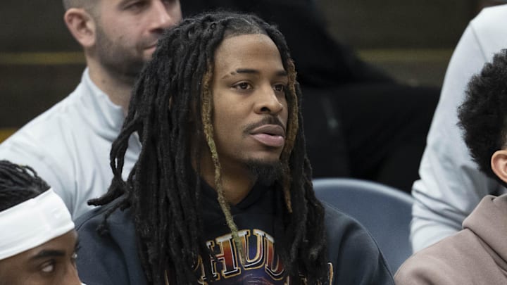 Dec 17, 2025; Minneapolis, Minnesota, USA; Memphis Grizzlies guard Ja Morant (12) looks on from the bench against the Minnesota Timberwolves in the second half at Target Center. Mandatory Credit: Jesse Johnson-Imagn Images