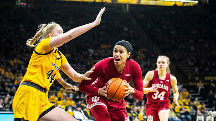 Indiana forward Kiandra Browne, center, drives to the basket against Iowa's Addison O'Grady during a NCAA Big Ten Conference women's basketball game, Monday, Feb. 21, 2022, at Carver-Hawkeye Arena in Iowa City, Iowa.