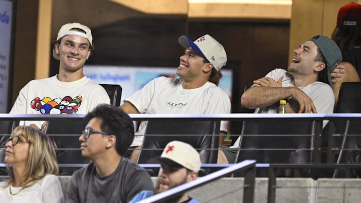 Sep 17, 2024; Arlington, Texas, USA; (from left) Dallas Stars center Wyatt Johnston and center Logan Stankoven and center Mavrik Bourque watch the game between the Texas Rangers and the Toronto Blue Jays at Globe Life Field. Mandatory Credit: Jerome Miron-Imagn Images