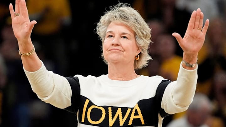 Former Iowa women’s basketball head coach Lisa Bluder, waves to the crowd during a recognition ceremony at halftime of the Iowa Hawkeyes game against the Maryland Terrapins Sunday, Jan. 5, 2025 at Carver-Hawkeye Arena in Iowa City, Iowa.