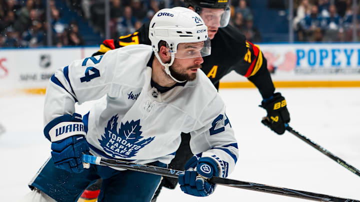 Jan 31, 2026; Vancouver, British Columbia, CAN; Vancouver Canucks defenseman Tyler Myers (57) defends against Toronto Maple Leafs forward Scott Laughton (24) in the third period at Rogers Arena. Mandatory Credit: Bob Frid-Imagn Images