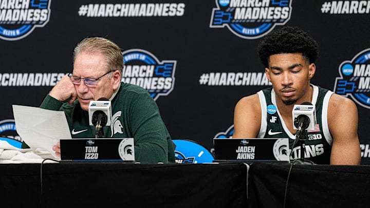 Michigan State head coach Tom Izzo, left, reads stats of the game as guard Jaden Akins (3) answers questions at post game press conference after 70-64 loss to Auburn at the Elite Eight round of NCAA tournament at State Farm Arena in Atlanta, Ga. on Sunday, March 30, 2025.