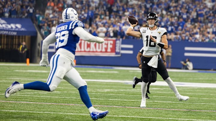 Sep 10, 2023; Indianapolis, Indiana, USA; Jacksonville Jaguars quarterback Trevor Lawrence (16) passes the ball tor a touchdown while Indianapolis Colts cornerback Darrell Baker Jr. (39) defends in the first quarter at Lucas Oil Stadium. Mandatory Credit: Trevor Ruszkowski-Imagn Images