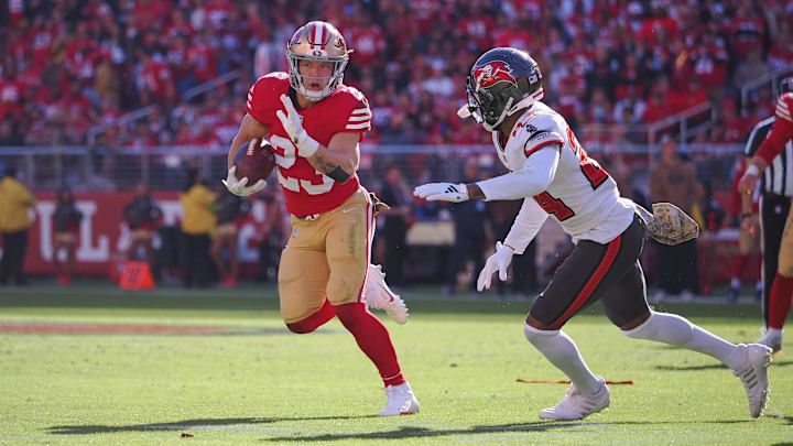 Nov 19, 2023; Santa Clara, California, USA; San Francisco 49ers running back Christian McCaffrey (23) carries the ball against Tampa Bay Buccaneers cornerback Carlton Davis III (24) during the first quarter at Levi's Stadium. Mandatory Credit: Kelley L Cox-Imagn Images Nov 19, 2023; Santa Clara, California, USA; San Francisco 49ers running back Christian McCaffrey (23) carries the ball against Tampa Bay Buccaneers cornerback Carlton Davis III (24) during the first quarter at Levi's Stadium. Mandatory Credit: Kelley L Cox-Imagn Images