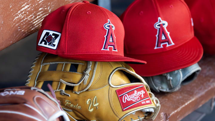Feb 28, 2025; Phoenix, Arizona, USA; Detailed view of the Los Angeles Angels logo on a hat in the dugout during a spring training game at Camelback Ranch-Glendale. Mandatory Credit: Mark J. Rebilas-Imagn Images