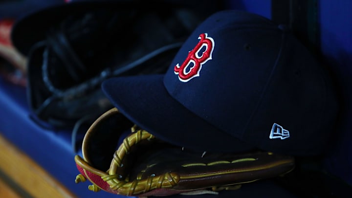 Jul 22, 2019; St. Petersburg, FL, USA; A detail view of Boston Red Sox hat and glove laying in the dugout at Tropicana Field. Mandatory Credit: Kim Klement-Imagn Images