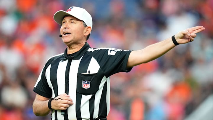 Aug 26, 2023; Denver, Colorado, USA; NFL referee Brad Allen (122) calls a personal foul penalty