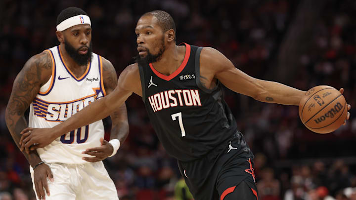 Jan 5, 2026; Houston, Texas, USA; Houston Rockets forward Kevin Durant (7) dribbles against Phoenix Suns forward Royce O'Neale (00) in the first quarter at Toyota Center. Mandatory Credit: Thomas Shea-Imagn Images