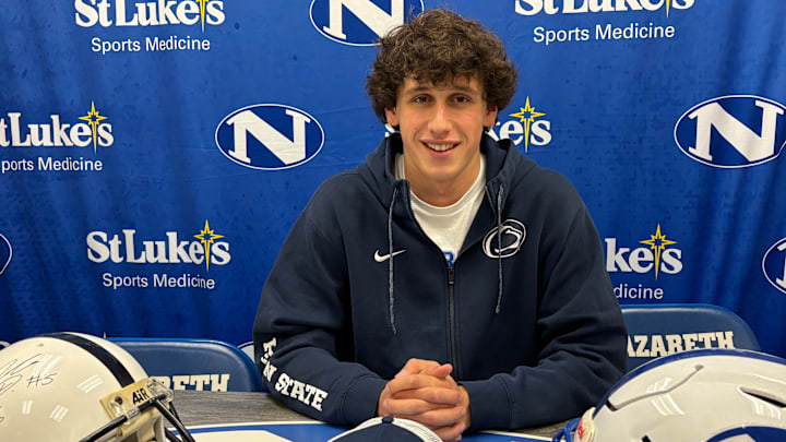 Penn State quarterback commit Peyton Falzone of Nazareth (Pa.) High at his Signing Day ceremony with Penn State and Nazareth helmets.